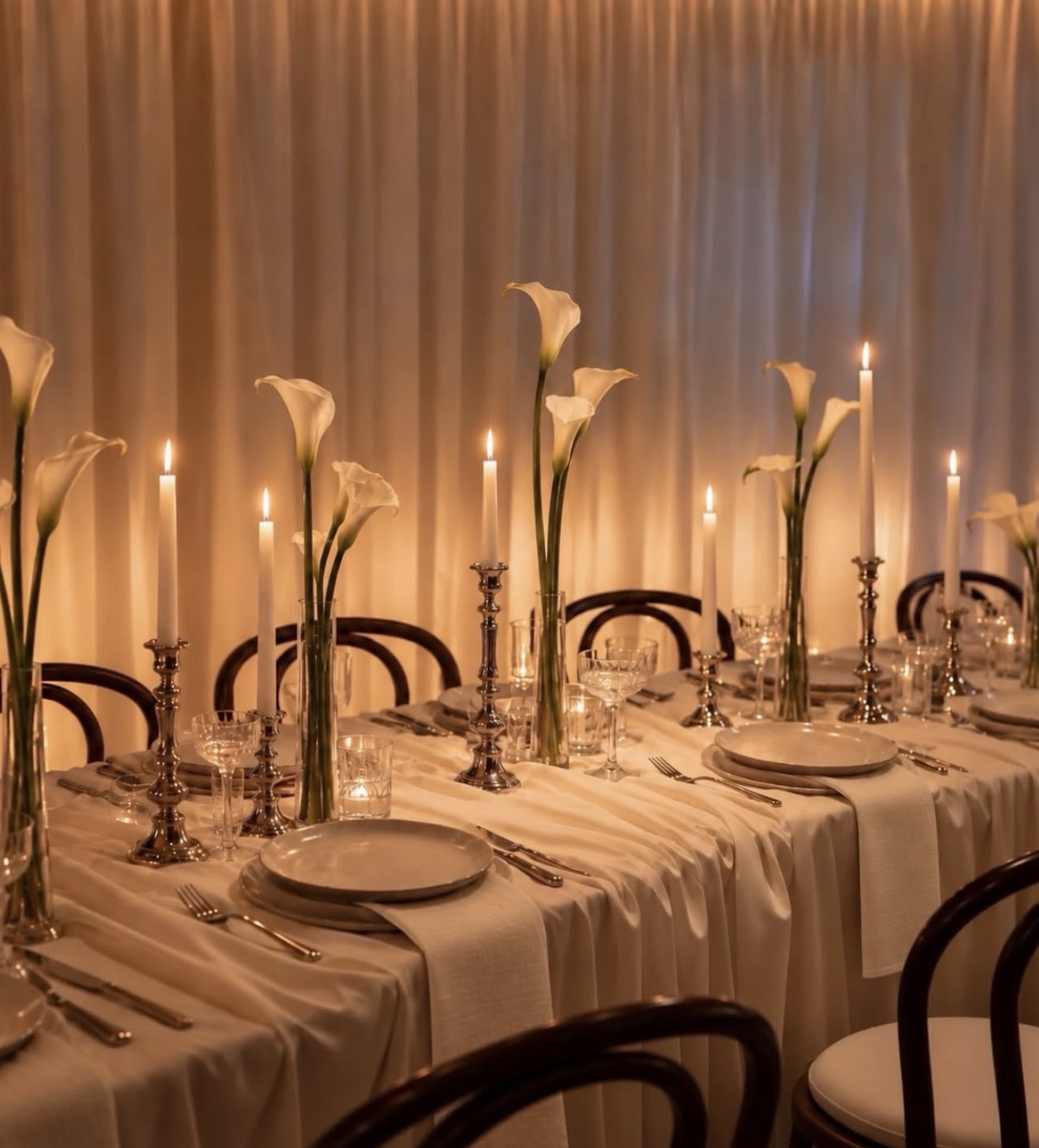 A wide evening view of the engagement party table with calla lilies and taper candles