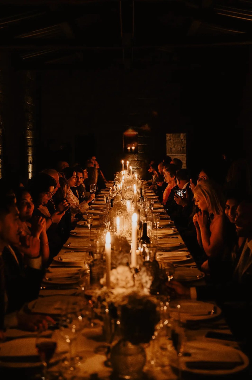 A long table prepared for an evening gathering