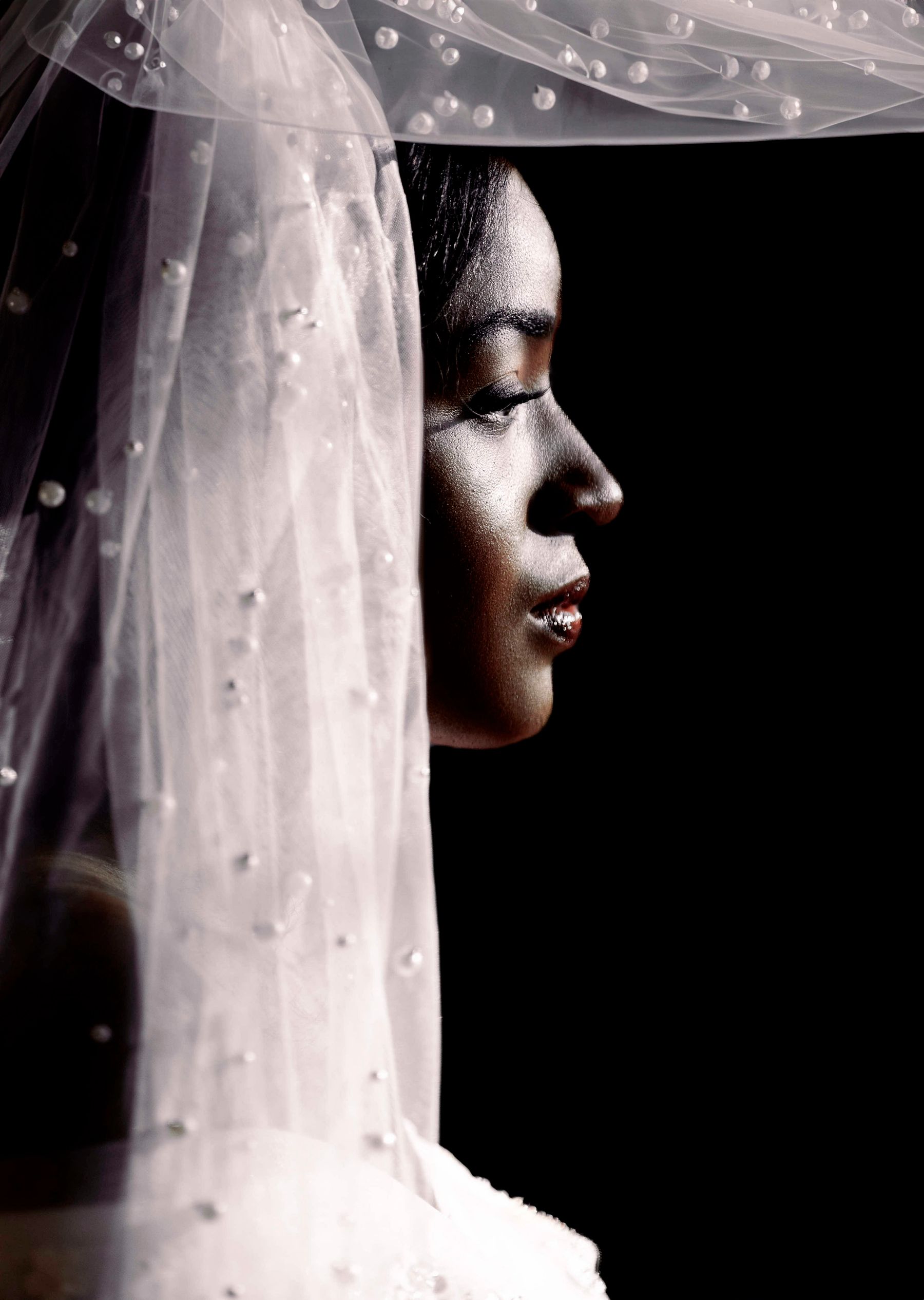 Bride in profile against deep black